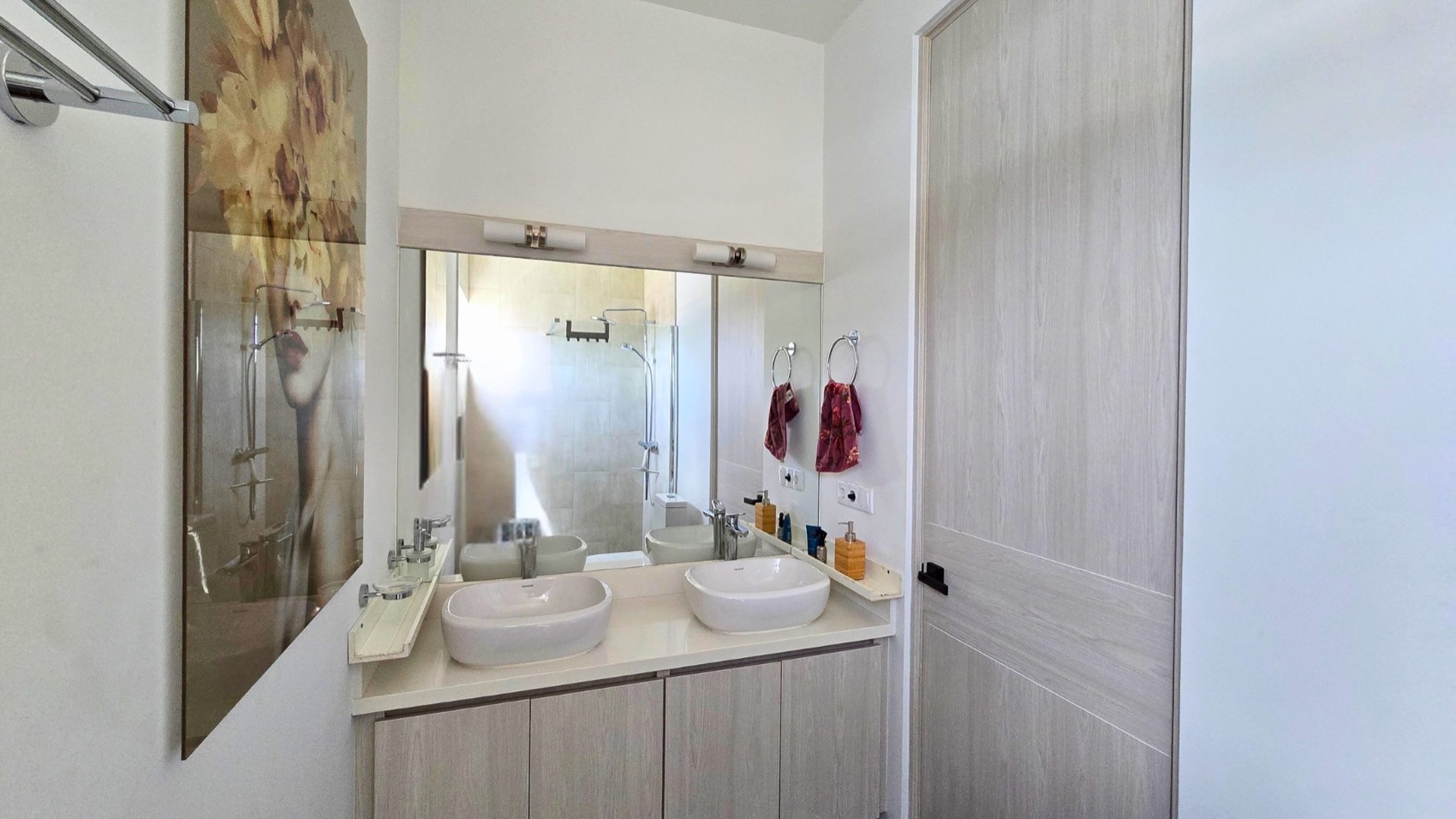 En-suite bathroom at Cur Azul with twin vessel sinks and a walk-in shower