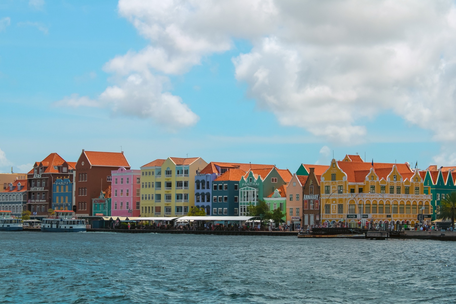 The candy-coloured Dutch-Caribbean waterfront houses of Willemstad, Curaçao reflected in the harbour